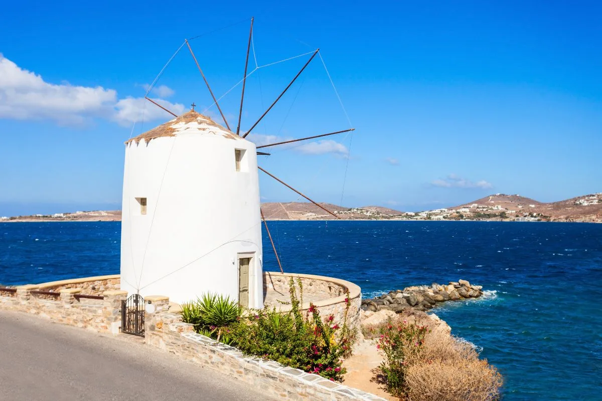 Discovering Santorini Alternatives| a windmill on the side of a road in Paros, Greece